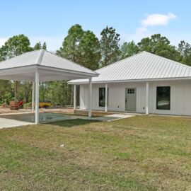 a white house with a lawn and Little White House with a white roof